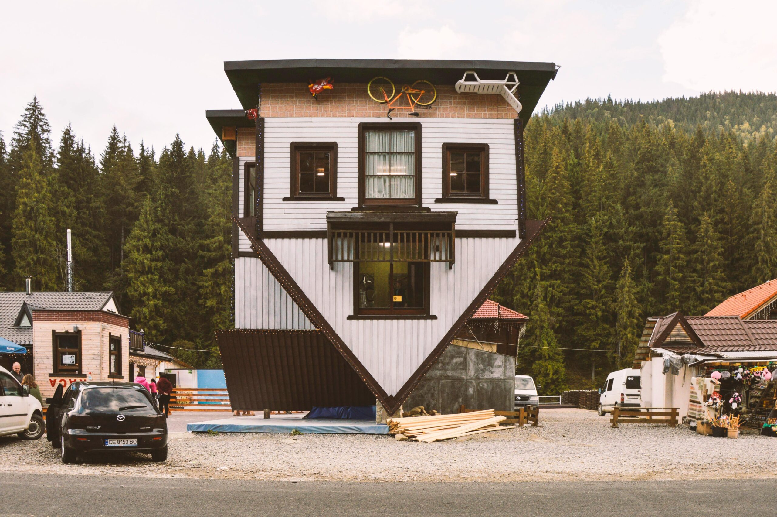 Explore the quirky upside-down house nestled in a lush forest in Poland, a must-see tourist attraction.